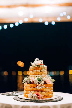 Wedding white bunk cake on a table at nightの写真素材
