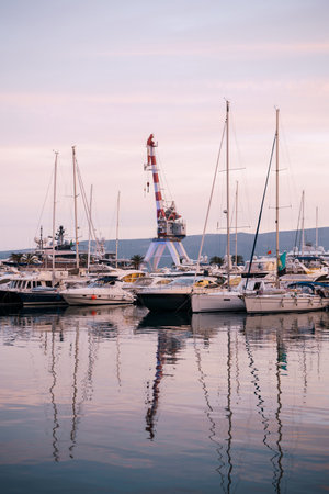 Yachts are moored at the pier with a crane in the background. Portoの写真素材