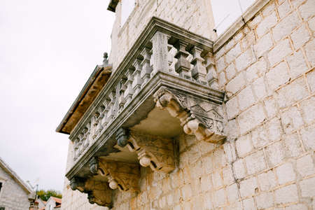 Carved stone balcony on the facade of the building with carved balustersの写真素材
