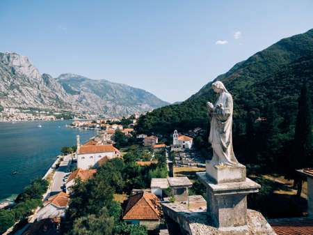 Statue of the Virgin Mary on the roof of the Church of the Nativity of the Virgin in Prcanjの写真素材