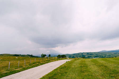 Barbed wire fence along a mountain road in a valley. Montenegroの写真素材