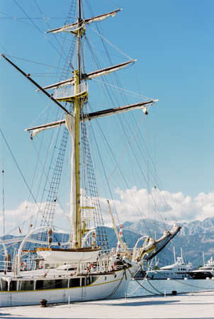 Bow of a white sailboat with a mast against the background of the mountains. Tivat, Montenegroの写真素材