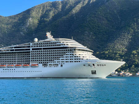 Huge cruise ship sails along the bay past the mountains. Montenegroの写真素材