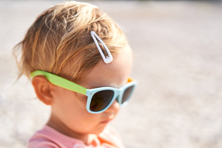Little girl in sunglasses with a hairpin on her head. Portraitの写真素材