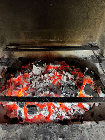 Smoldering coals in the fireplace. Close-up