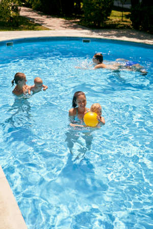 Mothers with young children swim in the pool