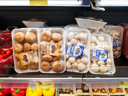 Budva, Montenegro - 06.07.22: Mushrooms in packages lie on a shelf in a supermarket among vegetablesのeditorial素材
