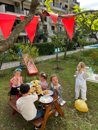 Budva, Montenegro - 01.08.22: Little children sit at the festive tableのeditorial素材