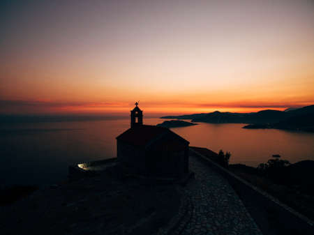 Church Sveti Savva near island Sveti Stefan at the sunrise time.の写真素材