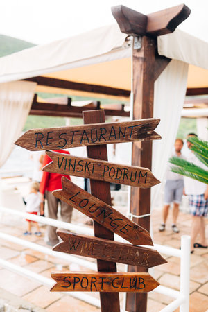 Wooden pointers on the background of the restaurant. People on backgroundの写真素材