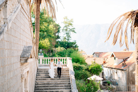 Kotor, Montenegro - 10 july 2020: The bride and groom going down the ancient stairs of the Nativity of the Blessed Virgin Mary church in Prcanjのeditorial素材