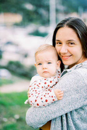 Mother holding the baby in her arms. Portraitの写真素材