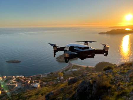 Budva, Montenegro - 01.08.22: Drone flies to shoot the island of Sveti Stefan at sunsetのeditorial素材
