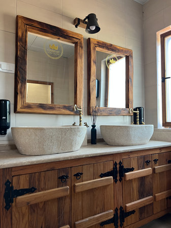 Budva, Montenegro - 27.08.2022: Bronze faucets over stone wash basins in the hotel bathroomのeditorial素材