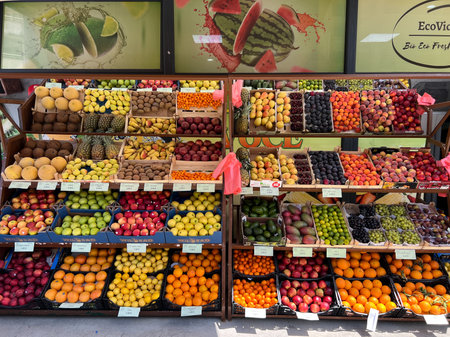 Budva, Montenegro - 27.08.2022: Crates with colorful fruits stand in front of a shop window on the streetのeditorial素材