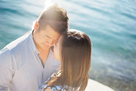 Man touches his forehead to the forehead of woman by the sea. Portraitの写真素材