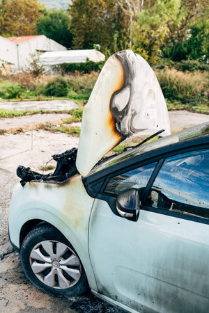 Budva, Montenegro - 17 march 2021: Citroen C3 2016 passenger car burnt out and extinguished by firefighters. Wiring under the hood caught fire.のeditorial素材