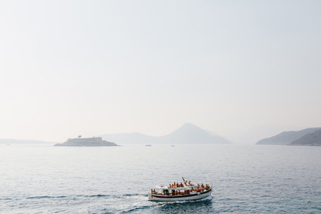 Lustica, Montenegro - 24.06.21: Boat with tourists is sailing to the Mamula island. Montenegroのeditorial素材