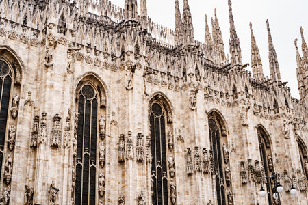 Milan, Italy - 07.04.18: Tall arched windows on the facade of the Duomo. Milan, Italyのeditorial素材
