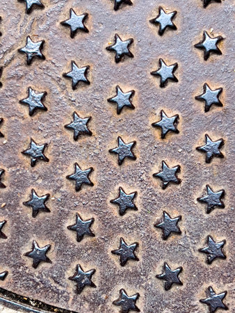 Metal stars of steel texture on a sewer manhole