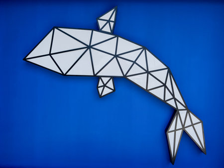 Decorative panel in the form of a whale on a blue wallの写真素材