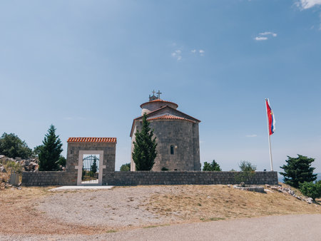 Flag flies on a flagpole near the Church of the Holy Trinity. Budva, Montenegro