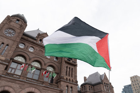 Toronto, Canada - 18 October 2023: Beneath the urban skies, heartfelt chants echo, symbolizing Torontos collective call for peace and understanding in Palestine.のeditorial素材
