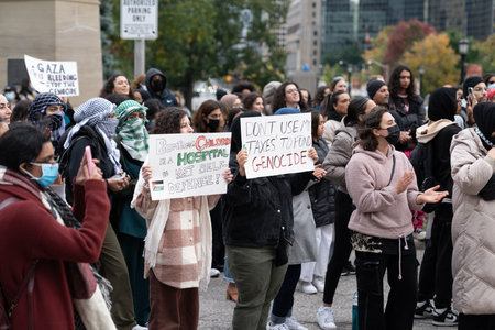 Toronto, Canada - 18 October 2023: The power of unity: individuals coming together for a shared cause against a cityscape.のeditorial素材
