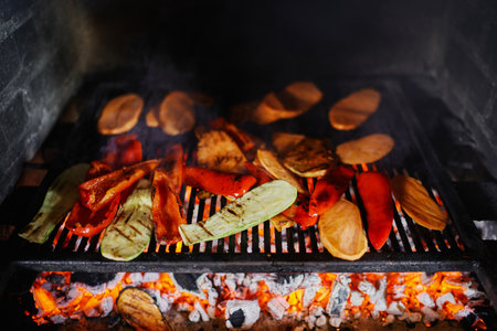Fresh chopped vegetables are baked on a grate in the oven
