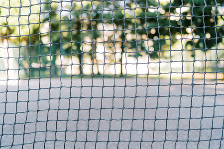Tennis net stretched on the court in the park