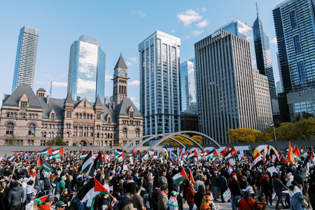 Toronto, Canada - 28 October 2023: Massive crowd gathers in the city center, waving Palestinian...