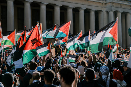 Toronto, Canada - 28 October 2023: Anti-war march in Toronto by Palestinians against Israels aggression in Gaza. Citys peaceful protest against Israel-HAMAS war. Protesters wave flagsのeditorial素材