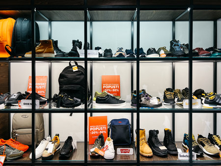Budva, Montenegro - 25 december 2022: Sports men shoes and accessories are on the shelves in a discount storeのeditorial素材