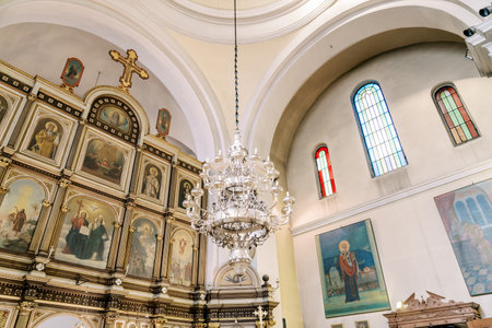 Large chandelier hangs from the ceiling of the church near the iconostasis