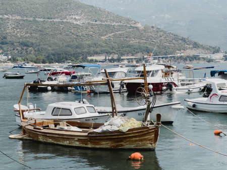 Budva, Montenegro - 08 august 2023: Small fishing boats are moored near the shoreのeditorial素材