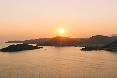 Colorful sunset in summer over mountains by the seaの写真素材