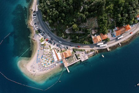 Private beach on a cape near the hotel near the highway on the seashore. Lepetane, Montenegro. Drone