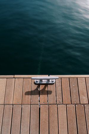 Wooden pier with bollard by the sea. Top viewの写真素材