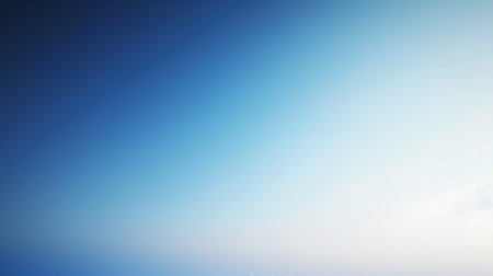 Electric blue sky meets white horizon in a blurred landscapeの素材