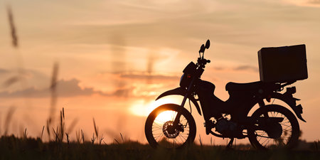 A motorcycle in nature at sunset, providing a peaceful momentの素材