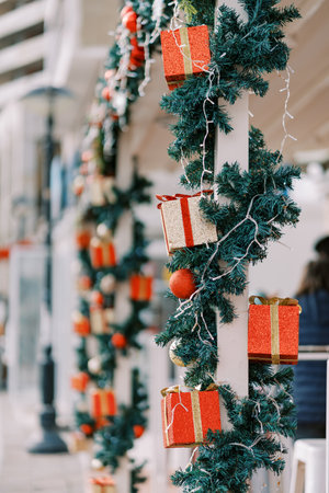 Columns of the building are decorated with colorful New Year garlandsの写真素材