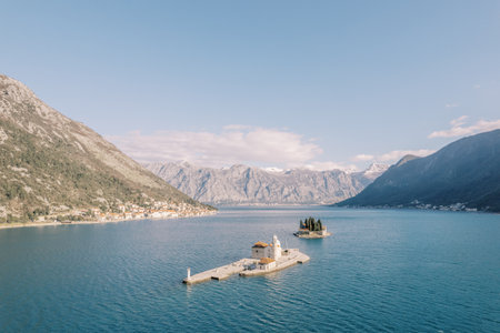 Island of Gospa od Skrpjela against the backdrop of the island of St. George in the Bay of Kotor....
