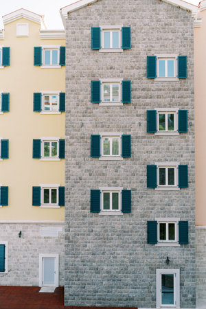 Colorful apartment buildings with green shutters on white windowsの写真素材