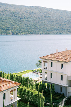 Hotel in a green garden near the pool on the seashore. Portonovi, Montenegro. High quality photoの写真素材