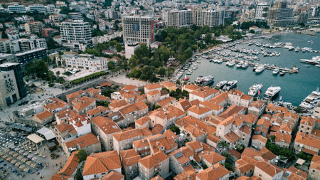 Old part of Budva next to the new part with multi-storey buildings by the sea. Montenegro. Drone. High quality photoの写真素材