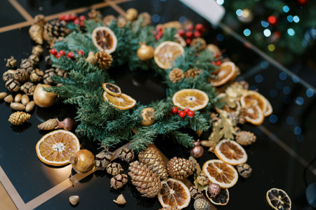 Christmas wreath with accessories for it on a table in the room. High quality photoの写真素材