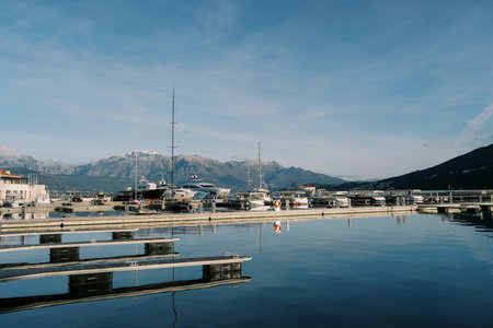 Pier with moored yachts against the backdrop of a mountain range. High quality photoの写真素材