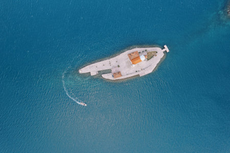 Motor boat sails around the island of Gospa od Skrpjela in the Bay of Kotor. Montenegro. Top view....