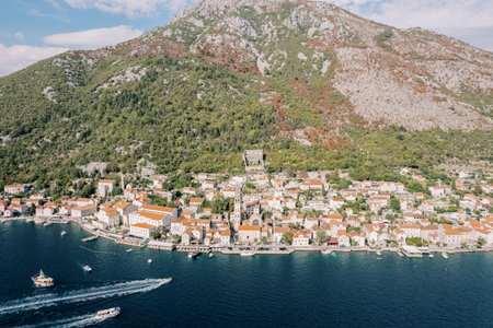 Motorboats sail along the Bay of Kotor to the coast. Perast, Montenegro. Drone