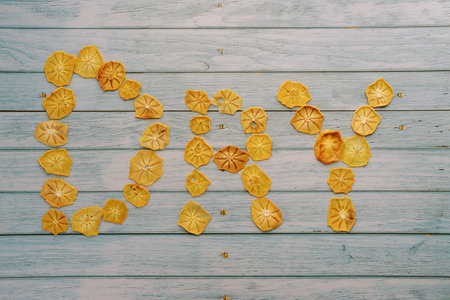 Dried fruits text on a wooden table. Caption: Dry